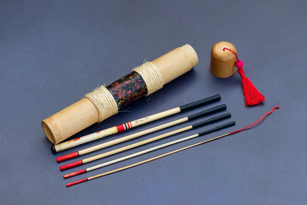 5-piece hand-built bamboo tanago rod set with hand-painted bamboo case and red tassel.