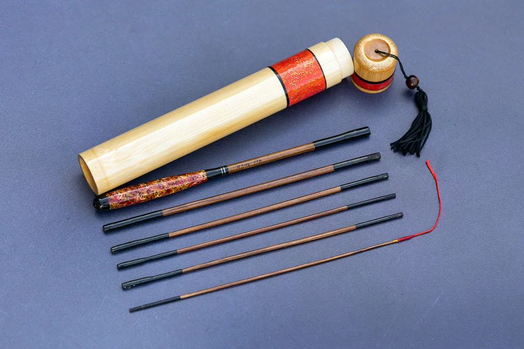 6-piece hand-built bamboo tanago micro fishing rod set with red hand-painted case and tassel.